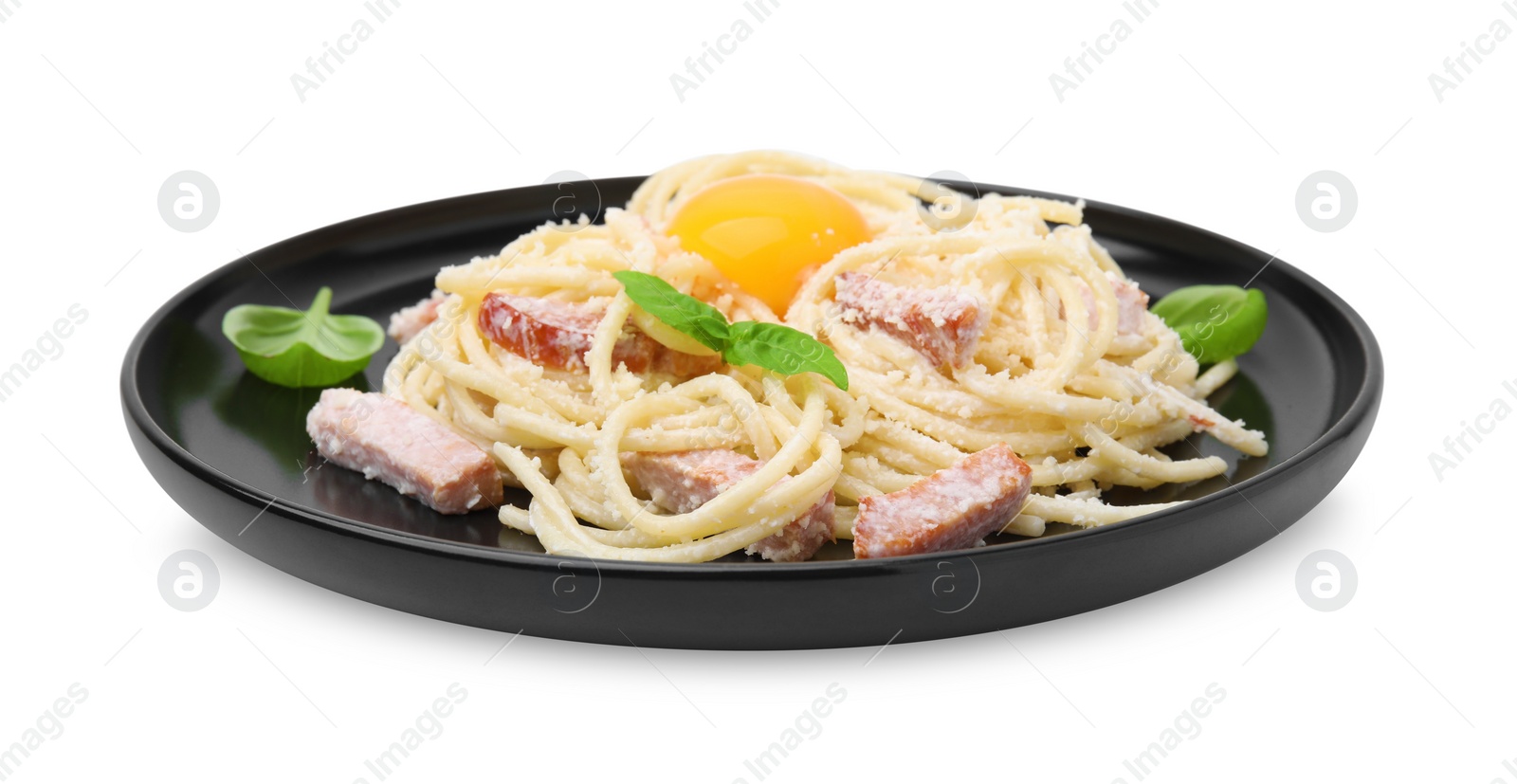 Photo of Plate of tasty pasta Carbonara with basil leaves and egg yolk isolated on white