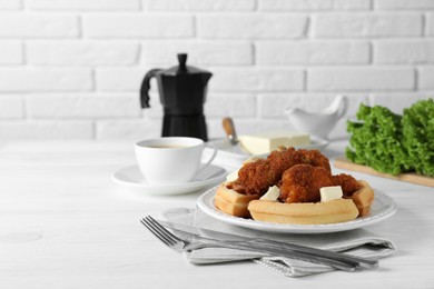 Photo of Delicious Belgium waffles served with fried chicken and butter on white table, space for text