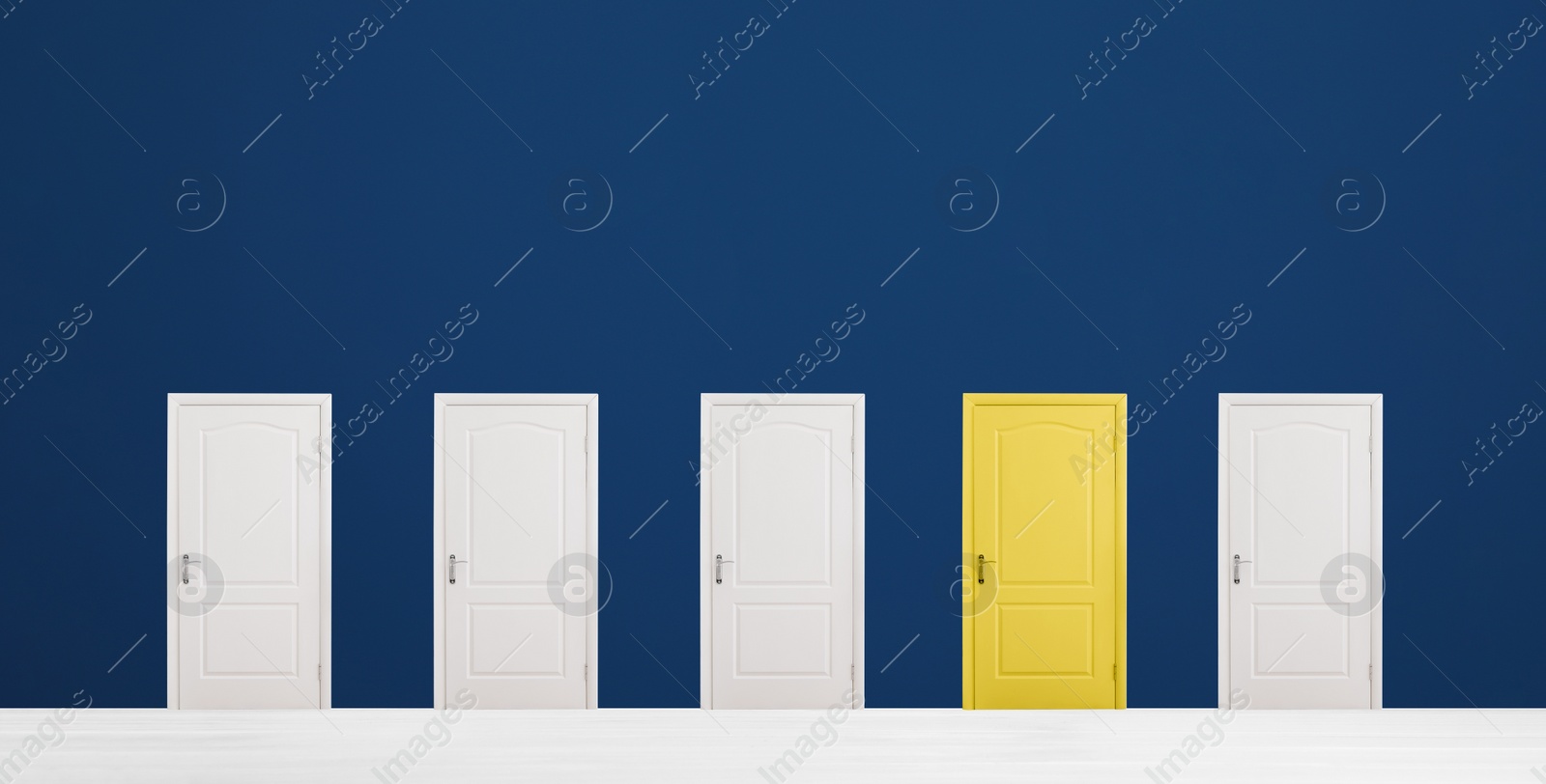 Image of Yellow door among white ones in room. Concept of choice