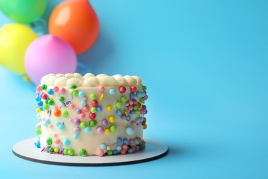 Photo of Cute bento cake with tasty cream on light blue background, space for text