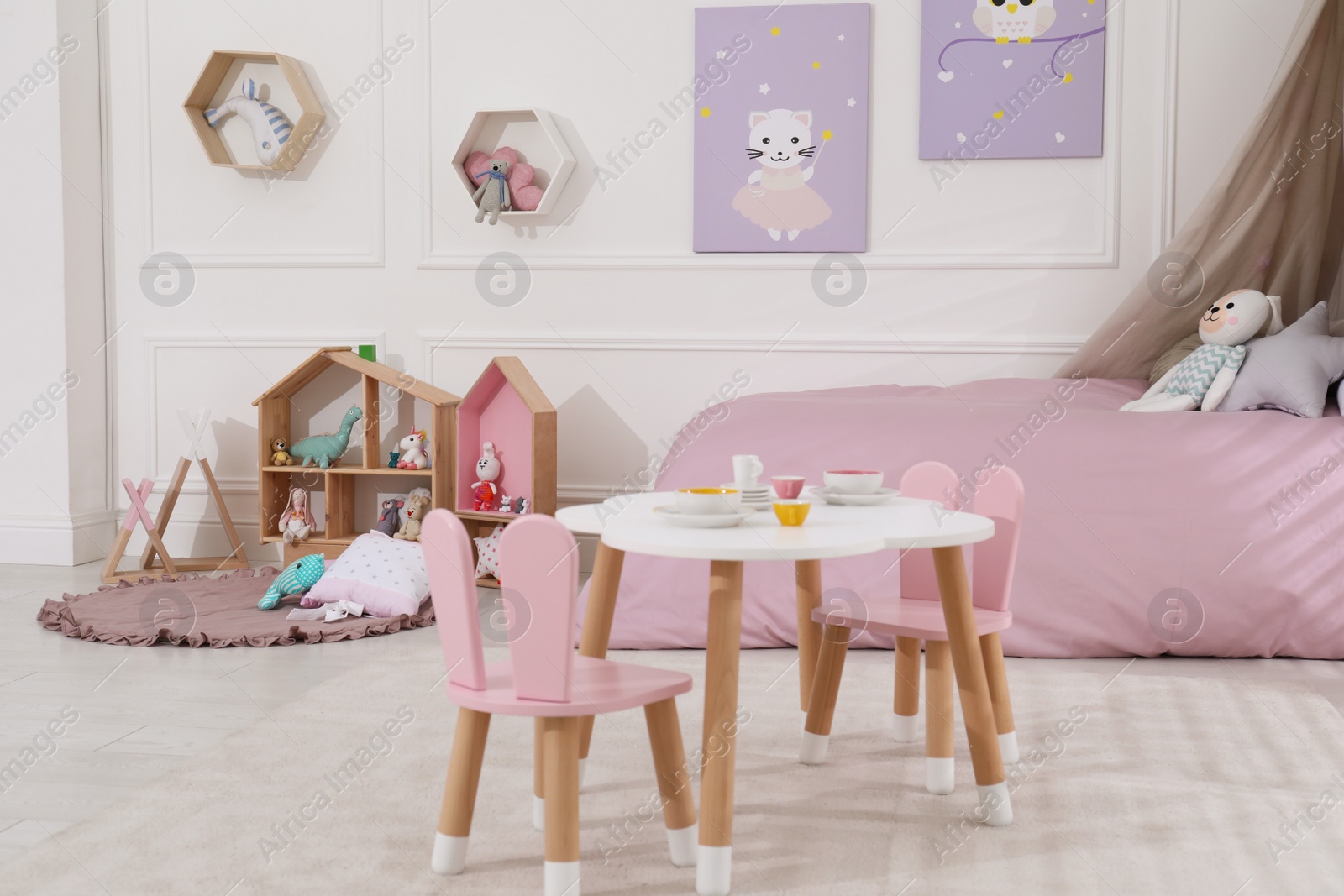 Photo of Cute child's room interior with toys and modern furniture