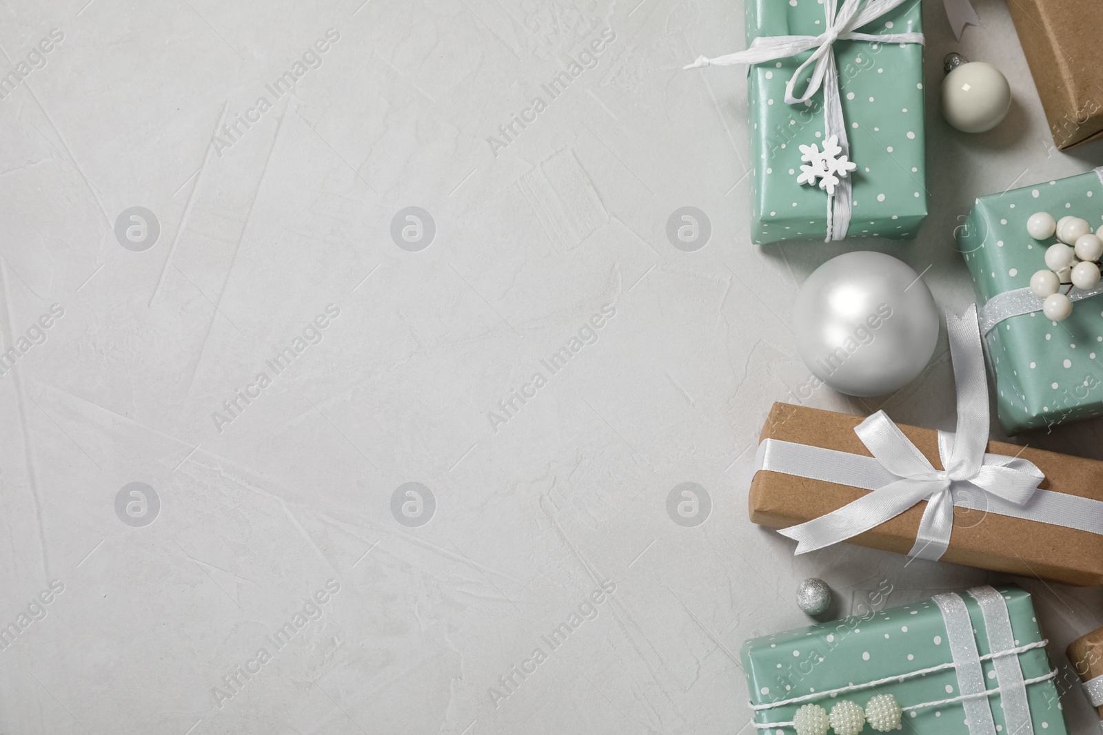 Photo of Flat lay composition of color Christmas gift boxes on light background. Space for text