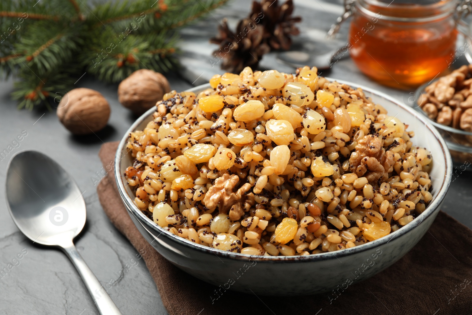 Photo of Traditional Christmas slavic dish kutia served on black table, closeup