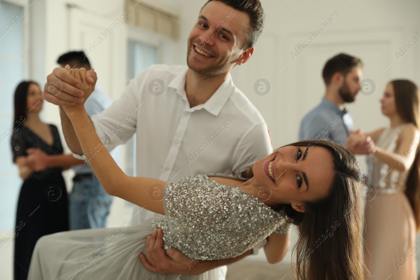 Photo of Lovely young couple dancing together at party