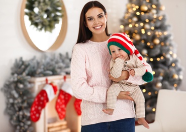 Mother with her cute baby at home. Christmas celebration