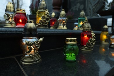 Photo of Grave lights on granite surface at cemetery