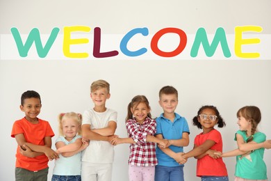 Image of Word Welcome over little children holding hands on light background