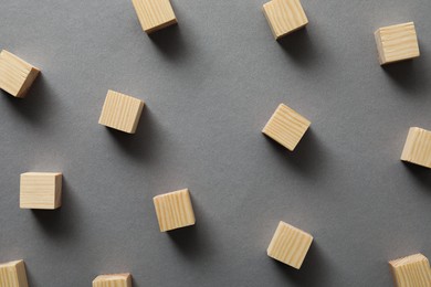 Photo of Many empty wooden cubes on grey background, flat lay