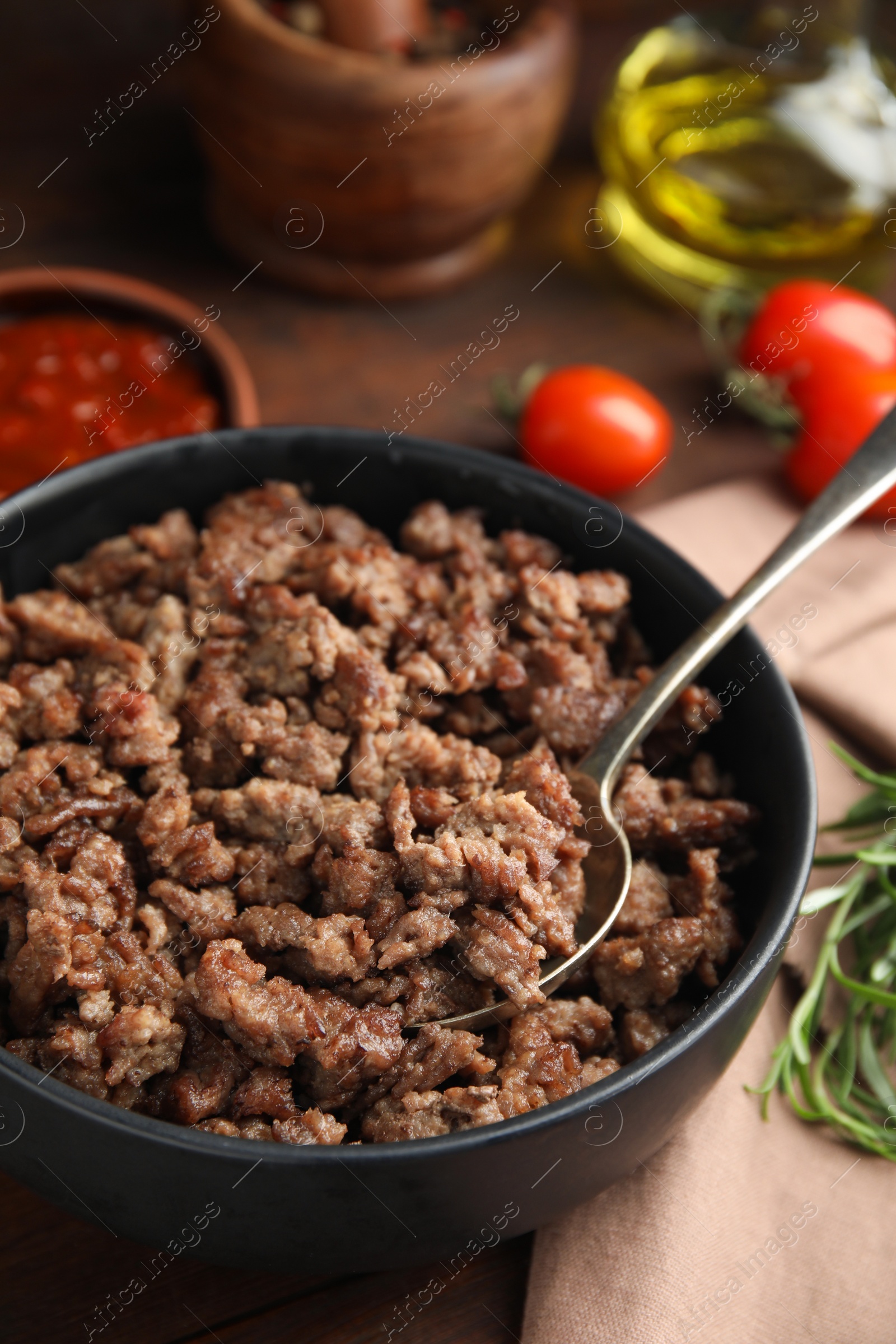 Photo of Fried minced meat and different products on wooden table, closeup