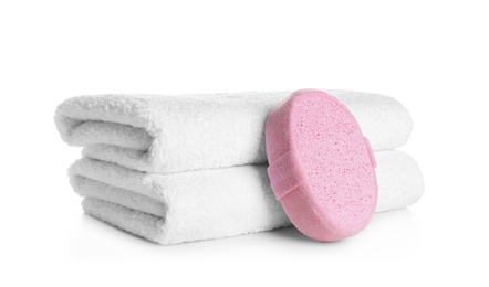 Photo of Stack of clean soft towels and sponge on white background