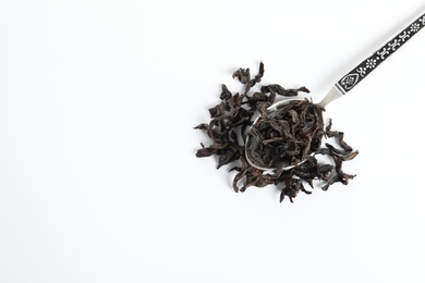 Photo of Spoon with Da Hong Pao Oolong tea on white background, top view