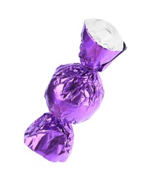 Photo of Tasty candy in purple wrapper isolated on white