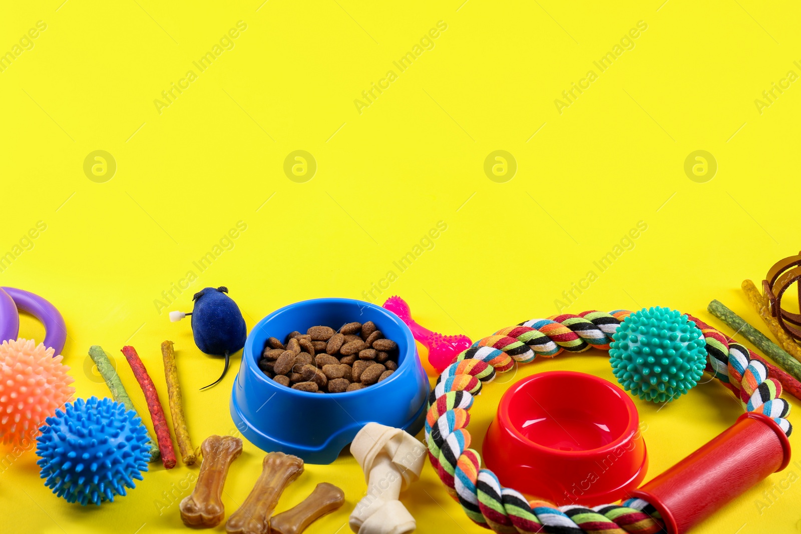 Photo of Different pet goods on yellow background, space for text. Shop assortment