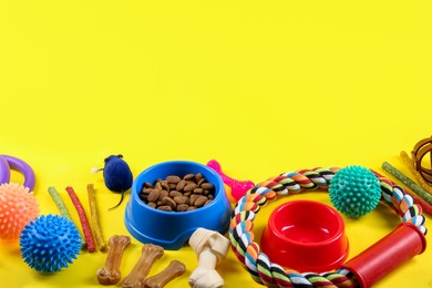 Different pet goods on yellow background, space for text. Shop assortment