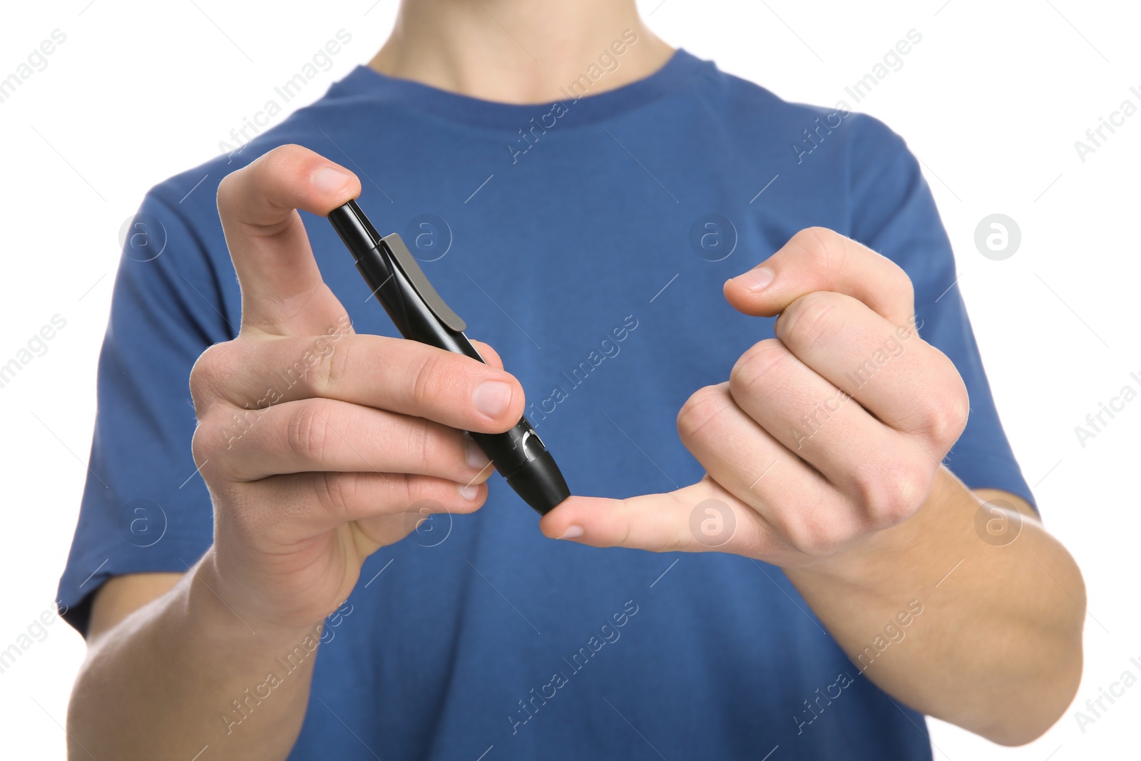 Photo of Teen boy using lancet pen on white background, closeup. Diabetes control