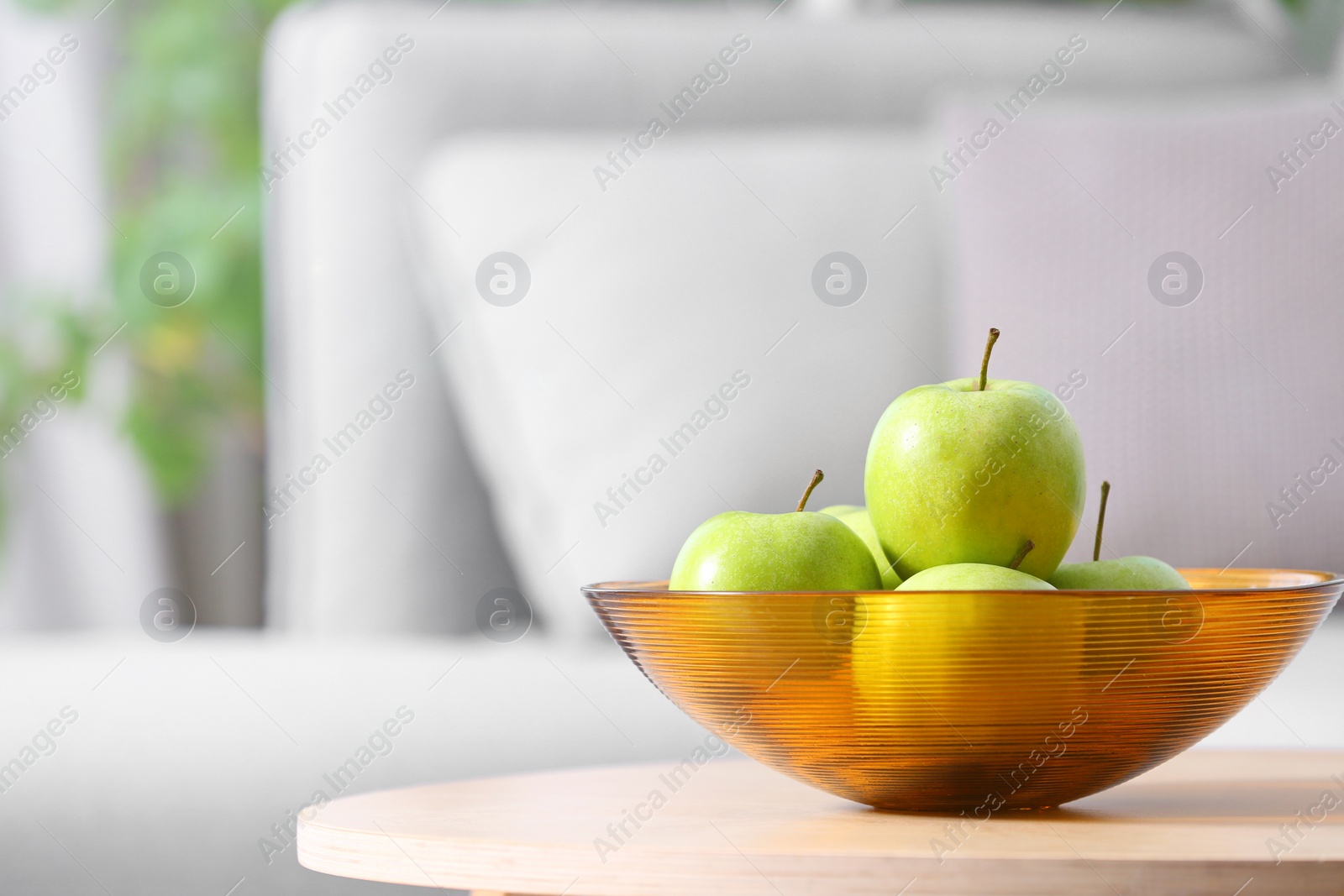 Photo of Bowl of fresh green apples on table indoors. Space for text