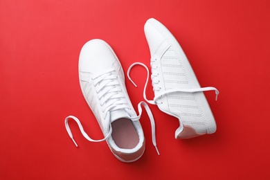 Photo of Pair of sneakers on color background, flat lay