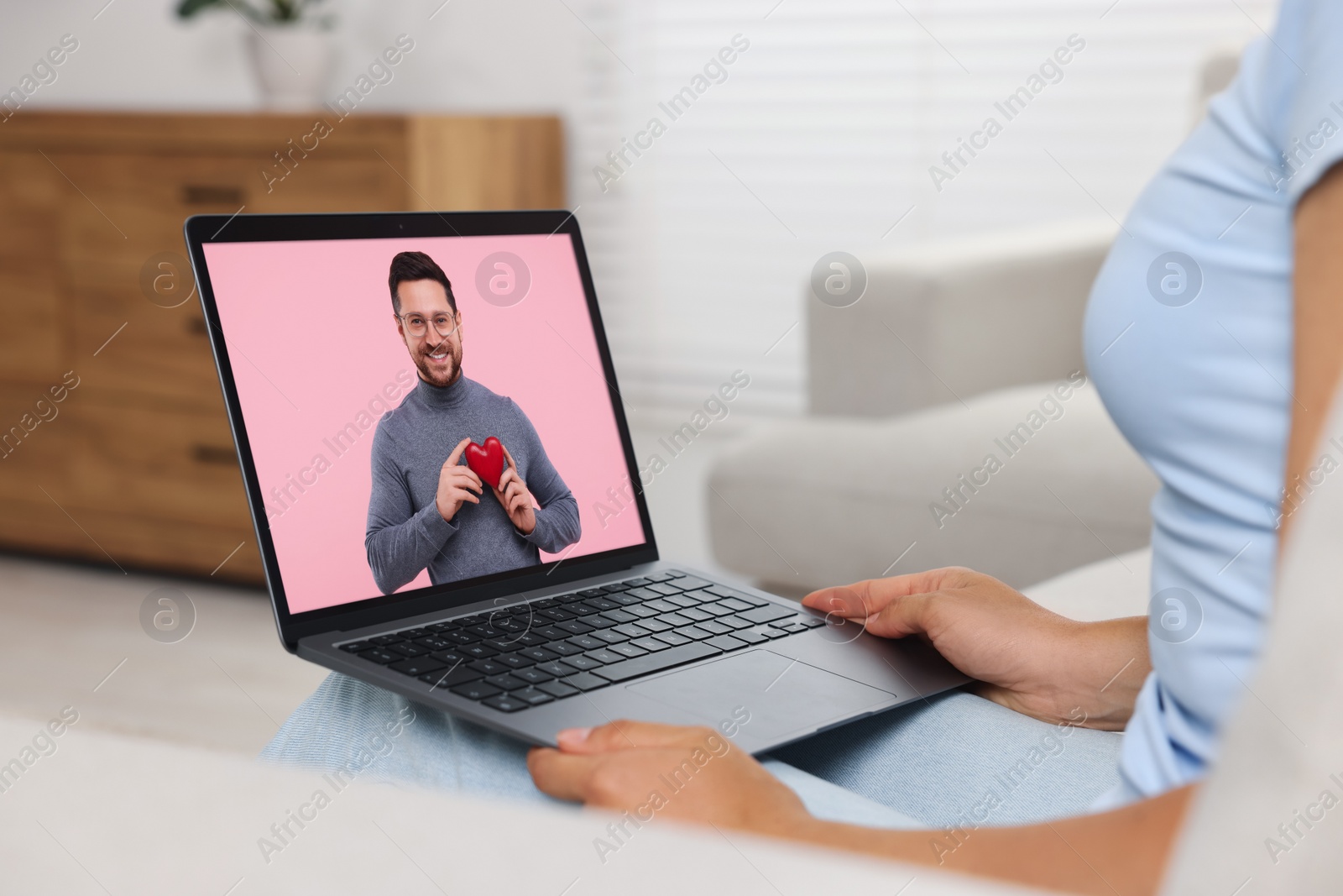 Image of Long distance love. Woman having video chat with her boyfriend via laptop at home, closeup