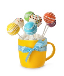 Delicious colorful cake pops in cup on white background