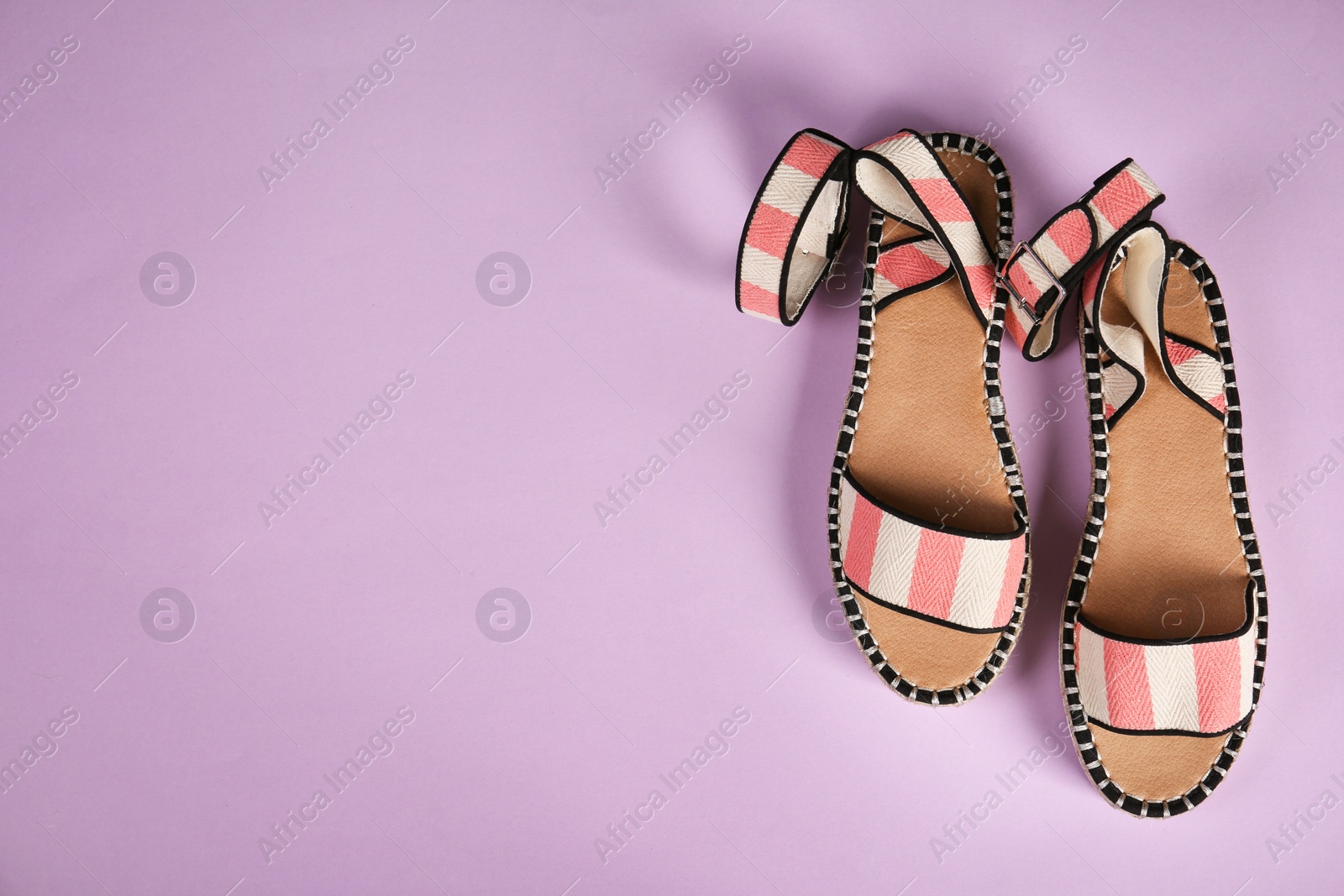 Photo of Pair of female shoes on color background, top view