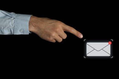 Email. Man touching virtual screen with incoming letter notification against black background, closeup