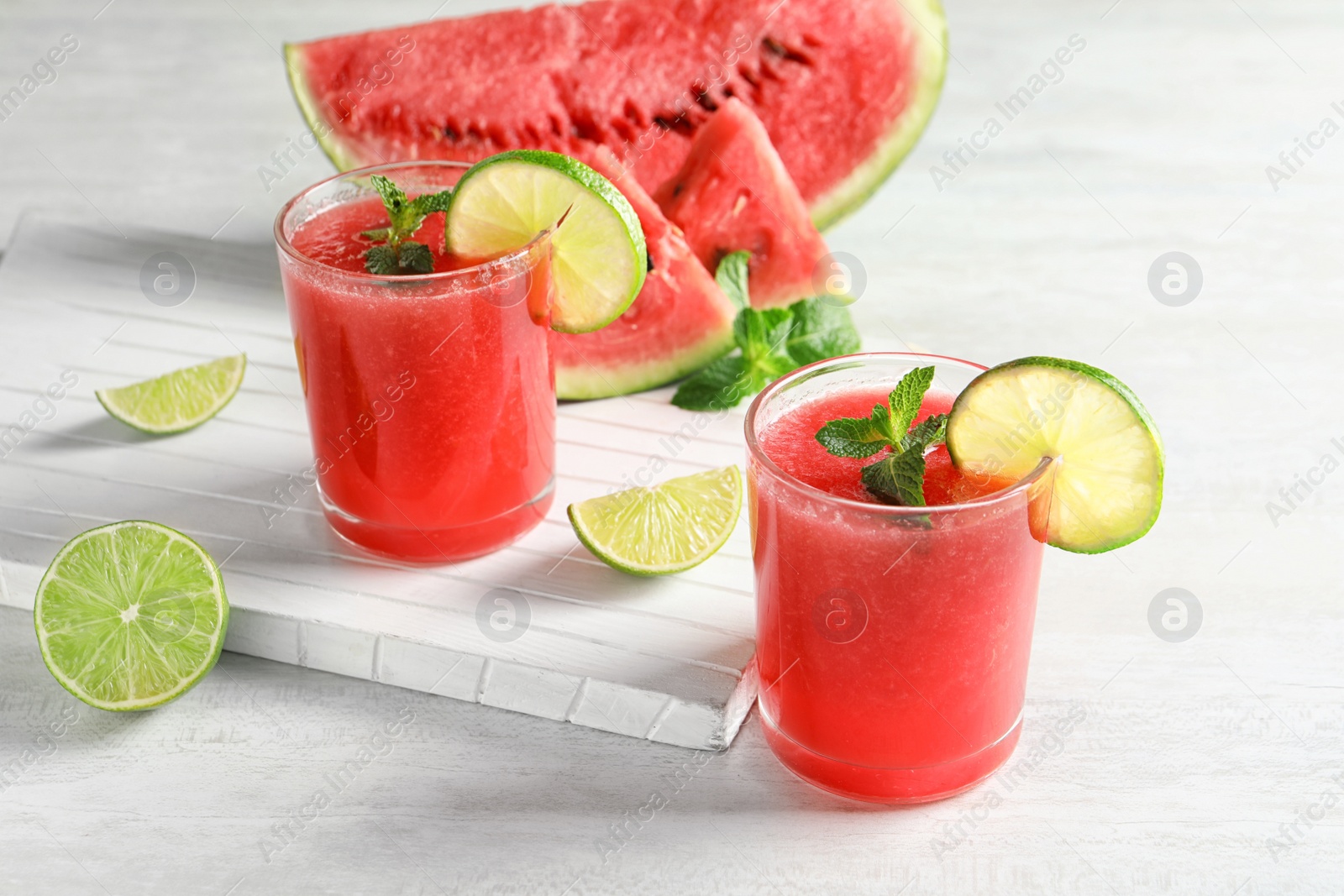 Photo of Tasty summer watermelon drink in glasses served on table