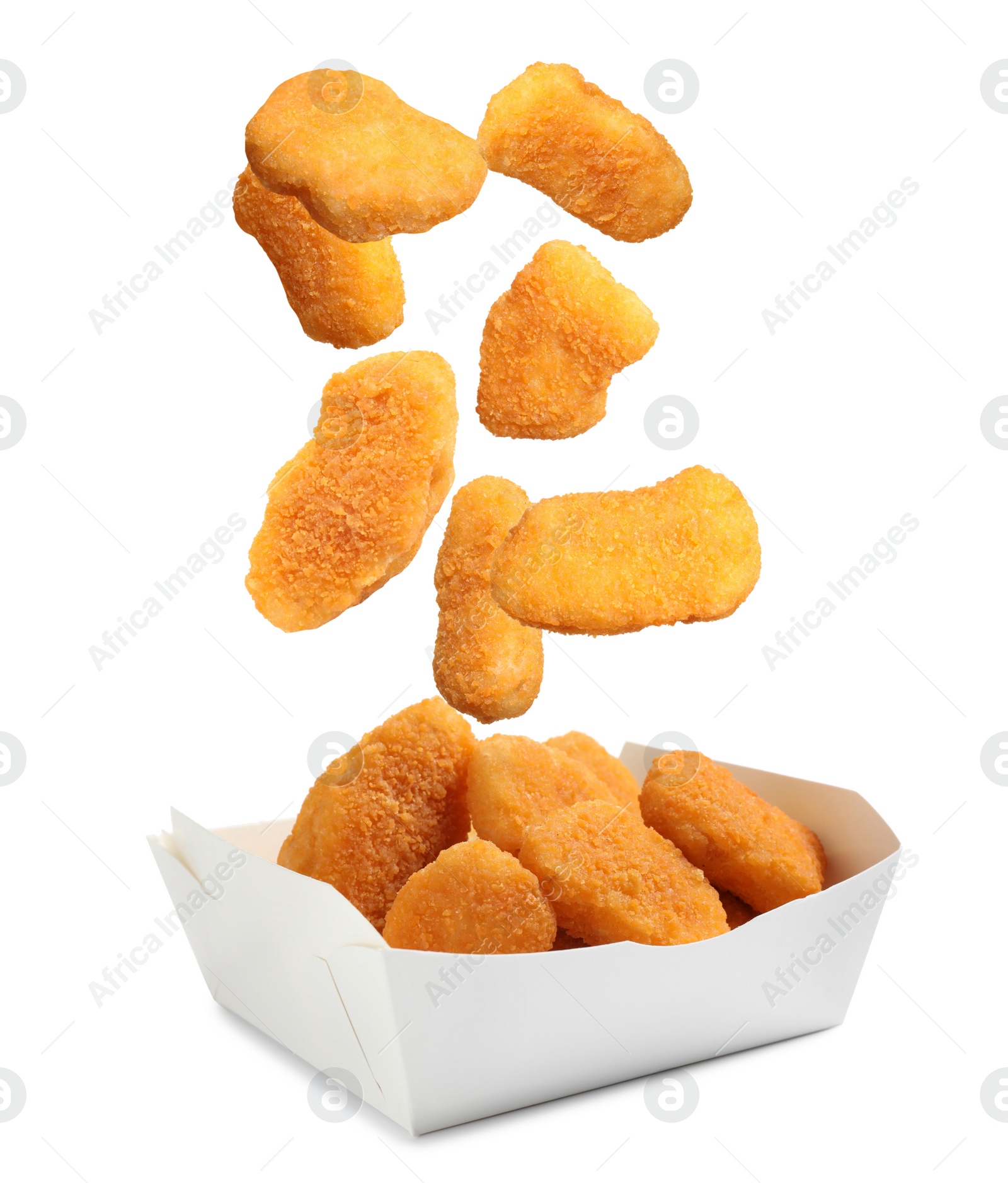 Image of Fresh chicken nuggets falling into container on white background