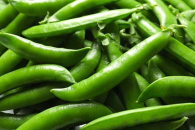 Photo of Many fresh green peas as background, closeup