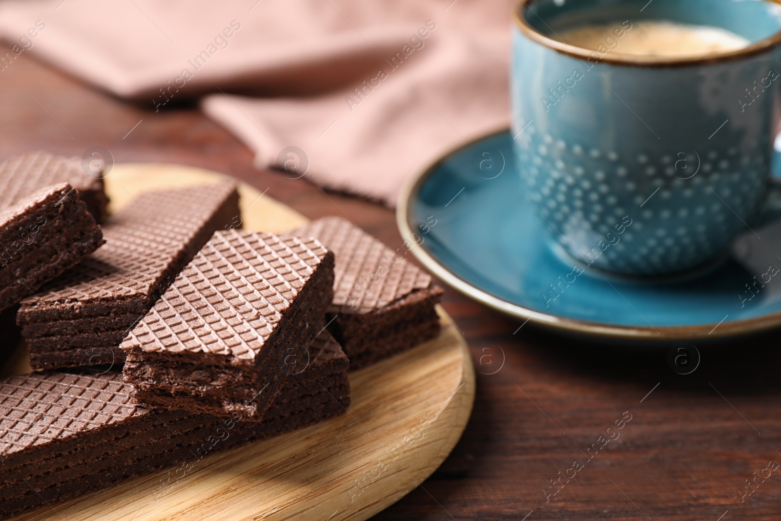 Photo of Delicious chocolate wafers on wooden table, closeup. Space for text