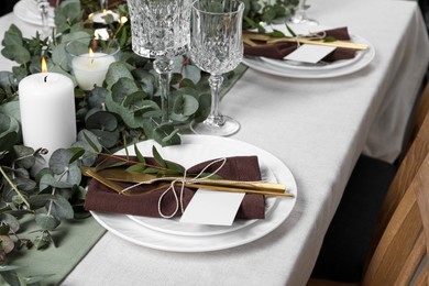 Luxury table setting with beautiful decor and blank cards. Festive dinner