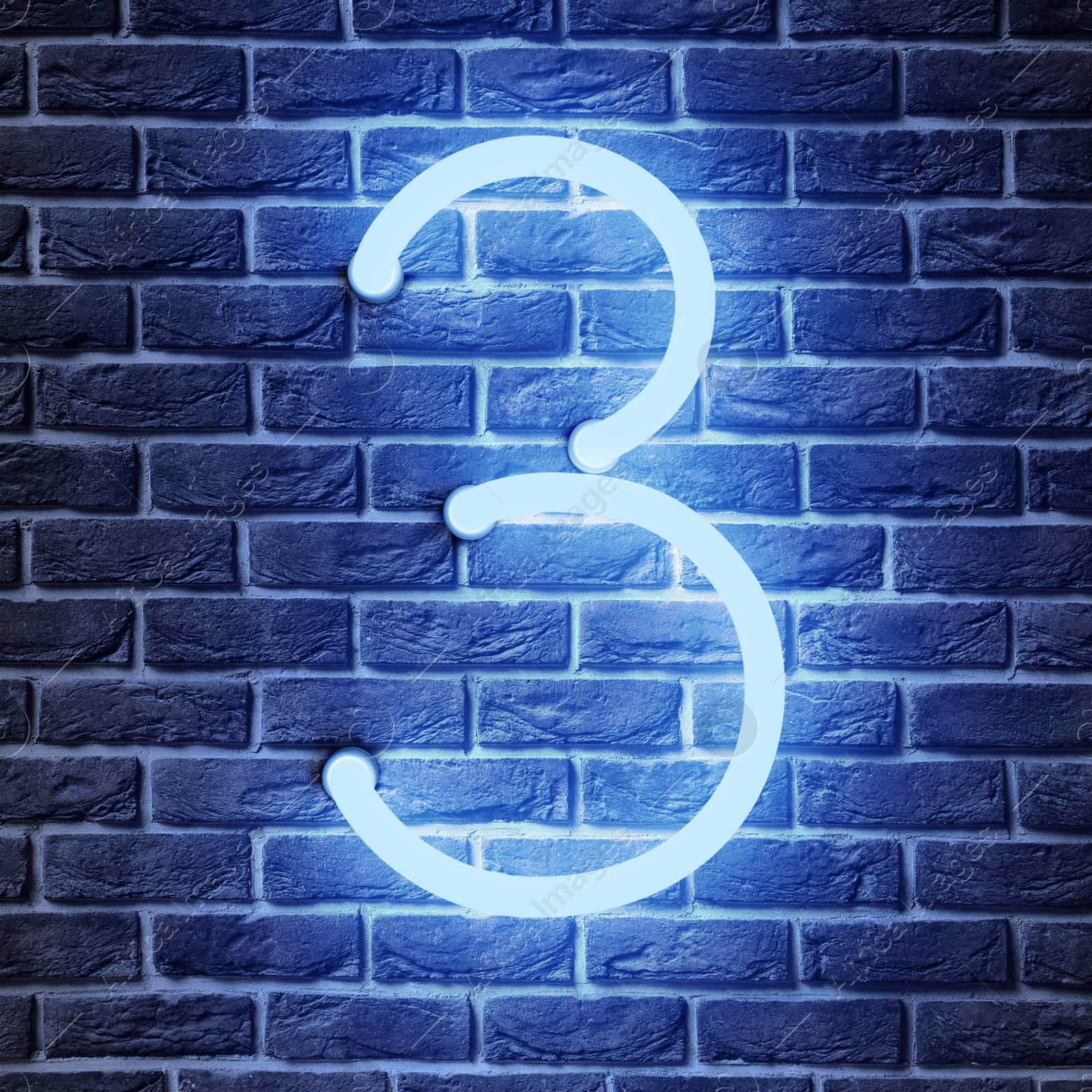 Image of Glowing neon number 3 sign on brick wall