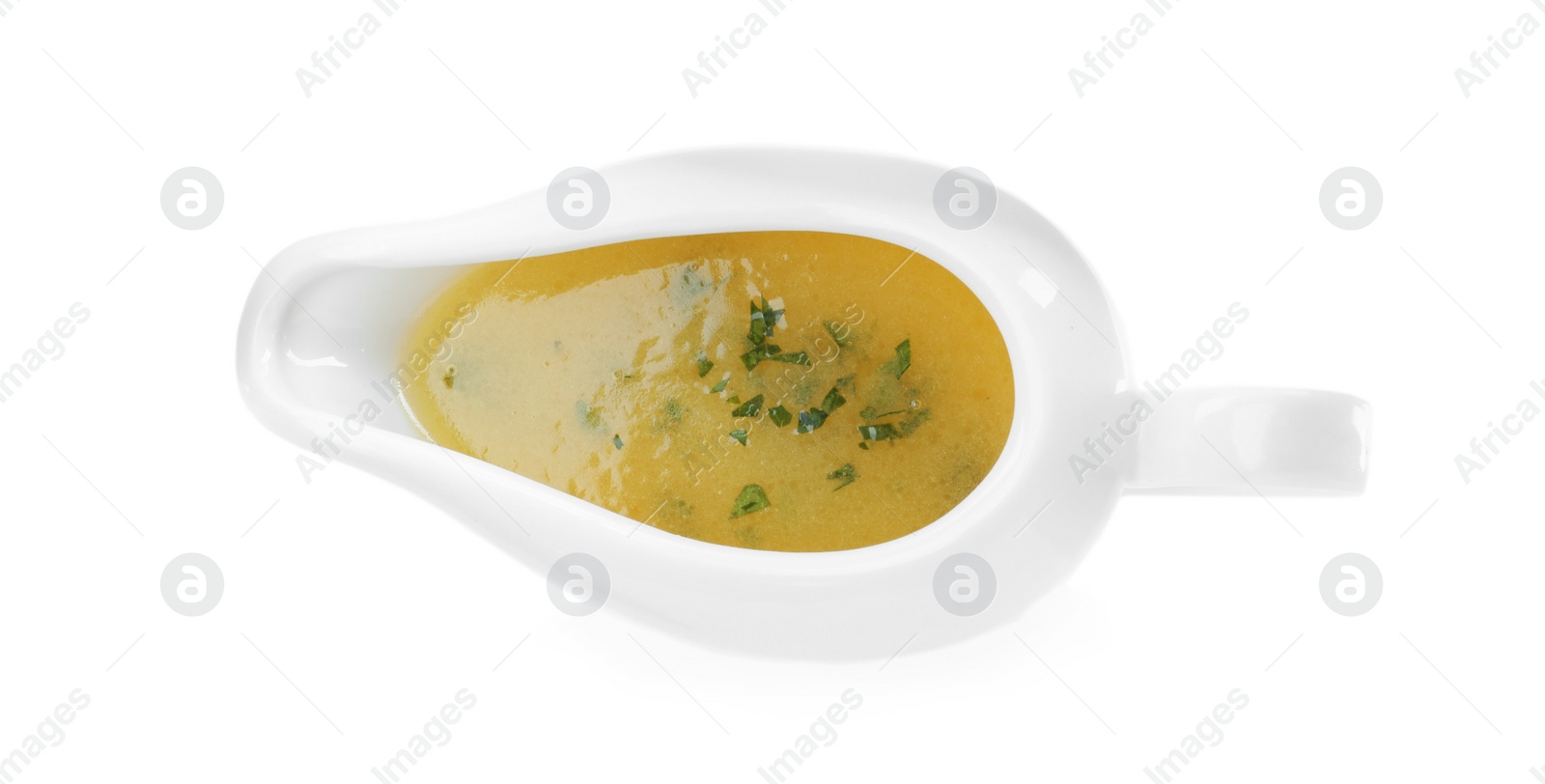 Photo of Ceramic sauce boat with lemon salad dressing on white background, top view