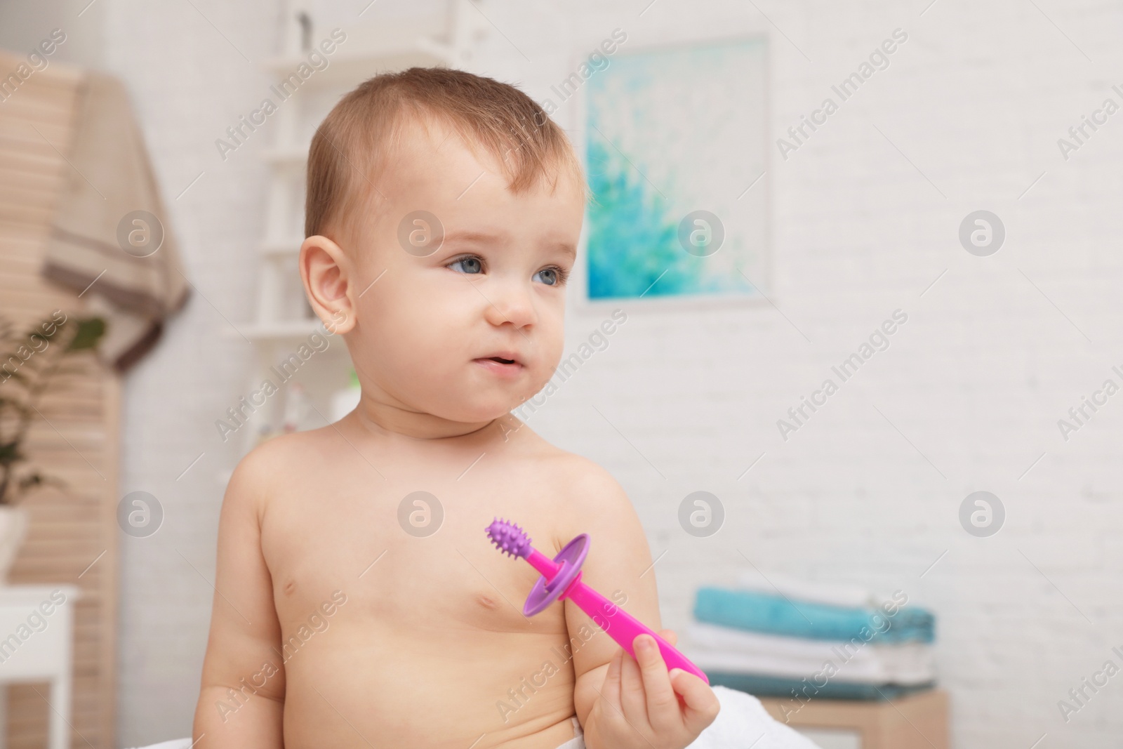 Photo of Cute little boy with toothbrush on blurred background