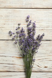 Photo of Beautiful fresh lavender flowers on white wooden background, top view