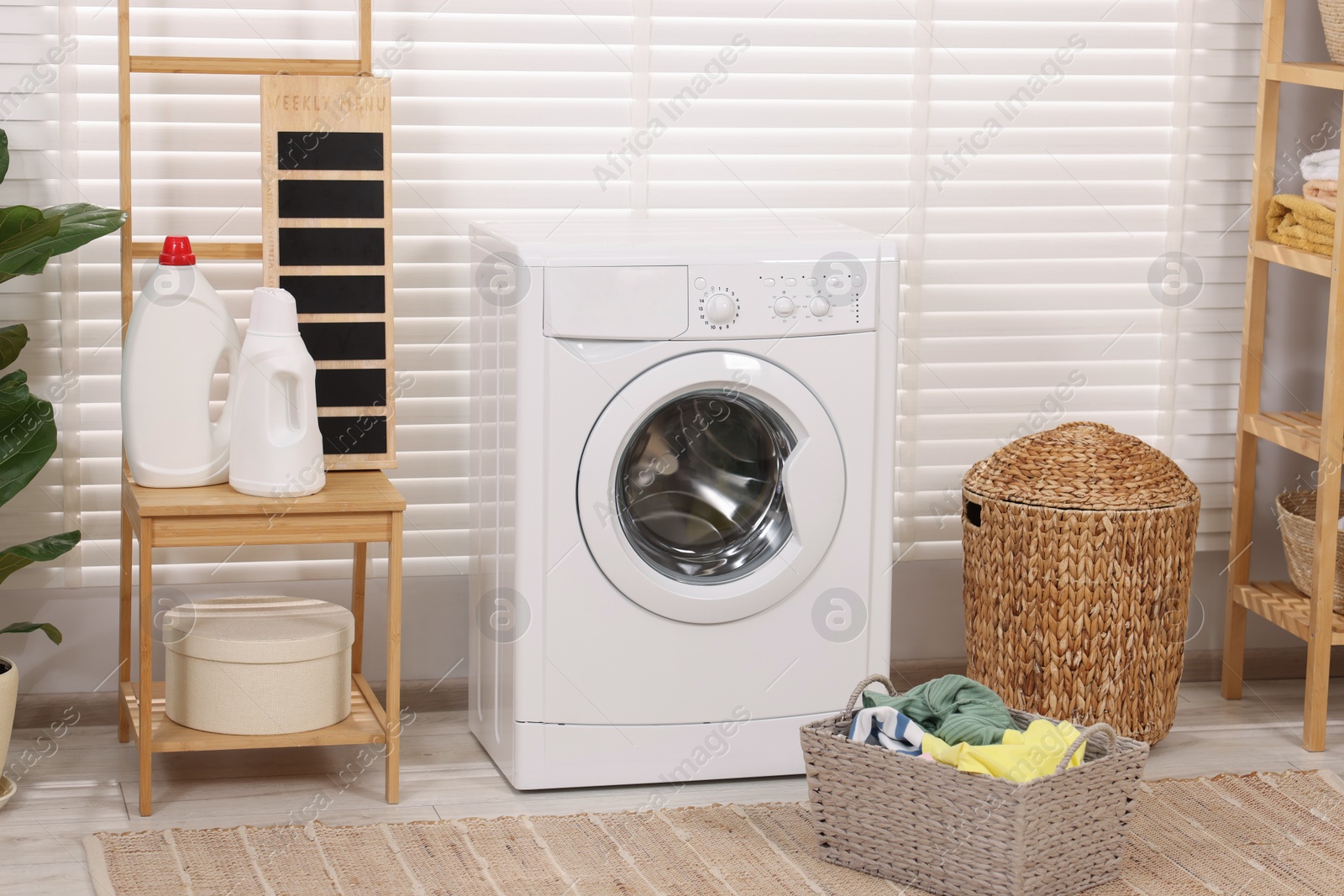 Photo of Laundry room interior with washing machine and baskets