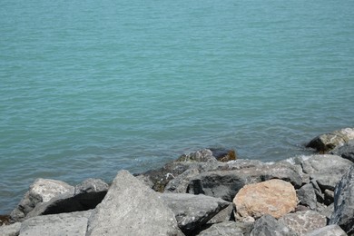 Beautiful view of sea coast with stones on sunny day