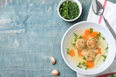 Photo of Flat lay composition with Jewish matzoh balls soup on wooden table. Space for text