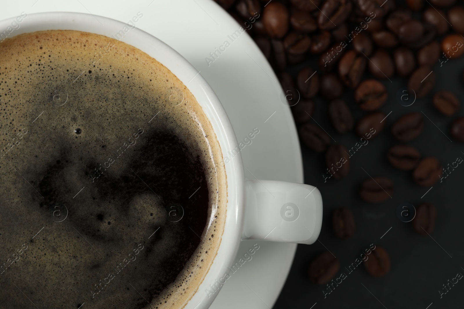 Photo of Cup of aromatic coffee on grey table, top view. Space for text