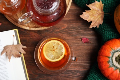 Flat lay composition with cup of hot drink on wooden table. Cozy autumn atmosphere