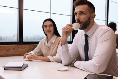 Coworkers talking in cafe during coffee break