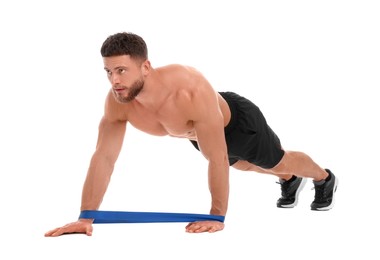 Photo of Young man exercising with elastic resistance band on white background