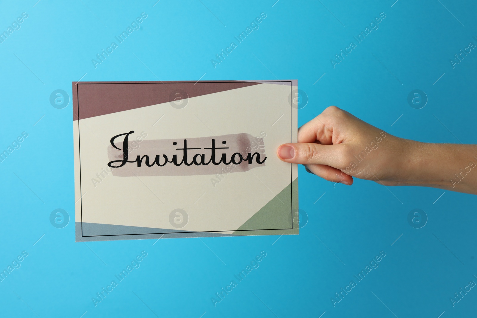 Photo of Woman holding beautiful card with word Invitation on light blue background, closeup