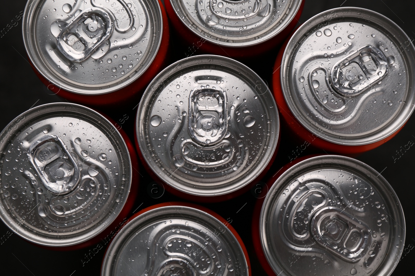 Photo of Energy drink in wet cans, top view. Functional beverage