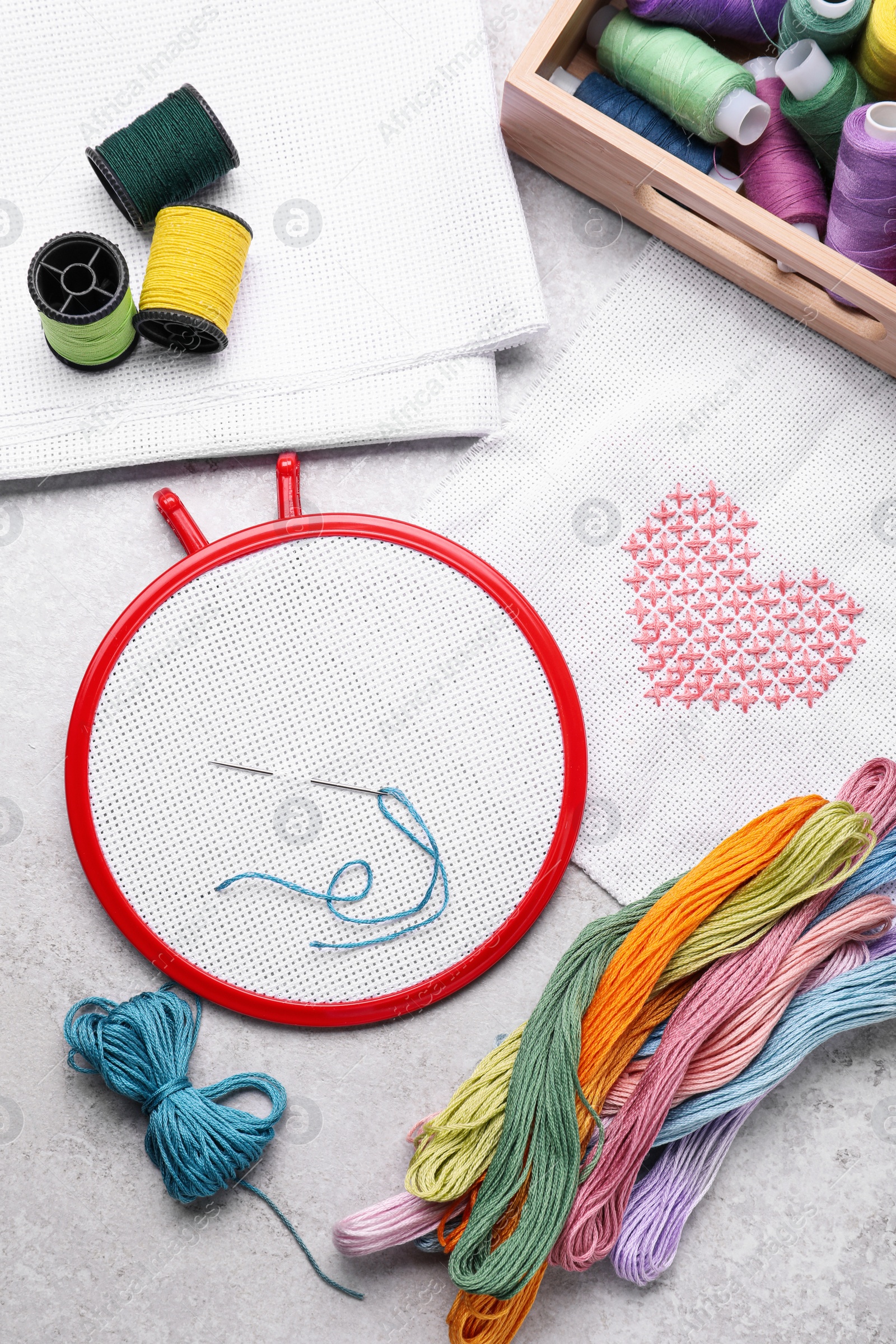 Photo of Flat lay composition with embroidery hoop on light grey background, top view
