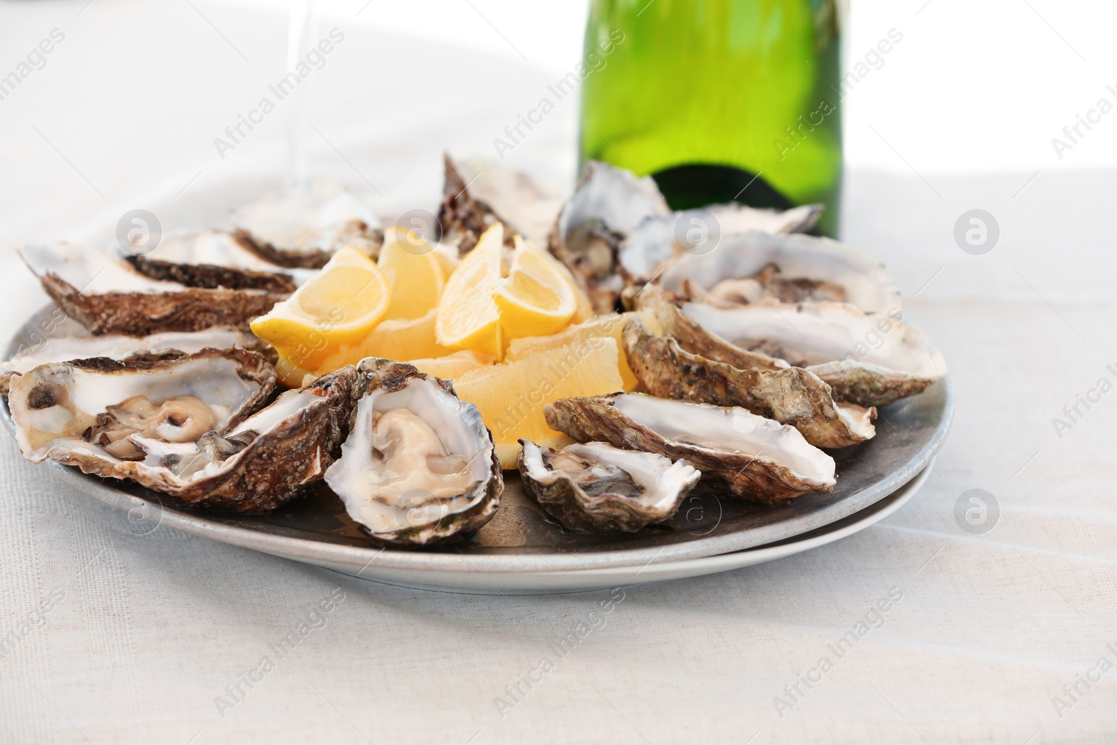 Photo of Fresh oysters with cut juicy lemon served on table