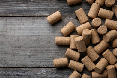 Photo of Wine bottle corks on wooden table, flat lay. Space for text