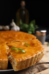 Delicious meat pie with basil on table, closeup. Space for text