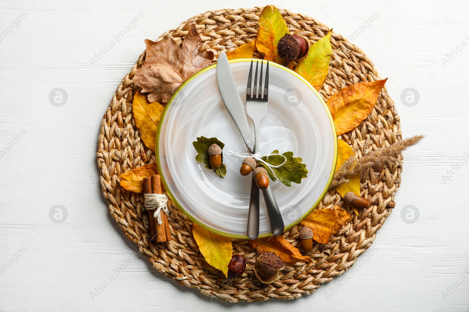 Photo of Autumn table setting with dry leaves on white wooden background, flat lay