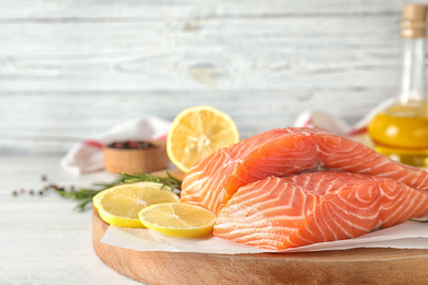 Photo of Fresh raw salmon with lemon on table. Fish delicacy