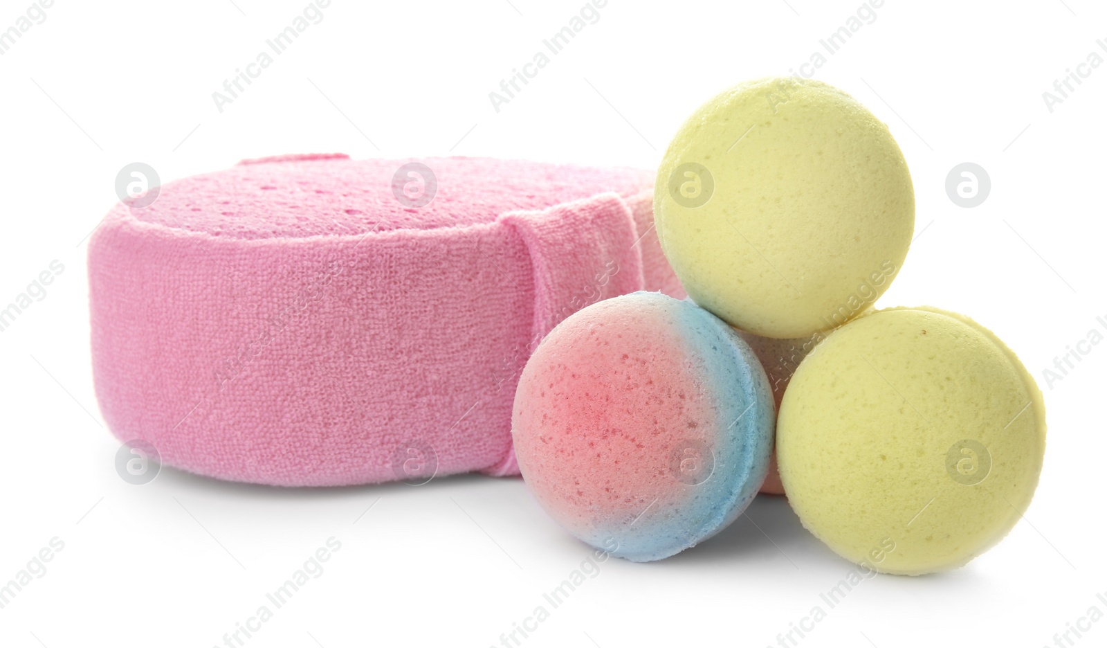 Photo of Pink sponge and bath bombs on white background